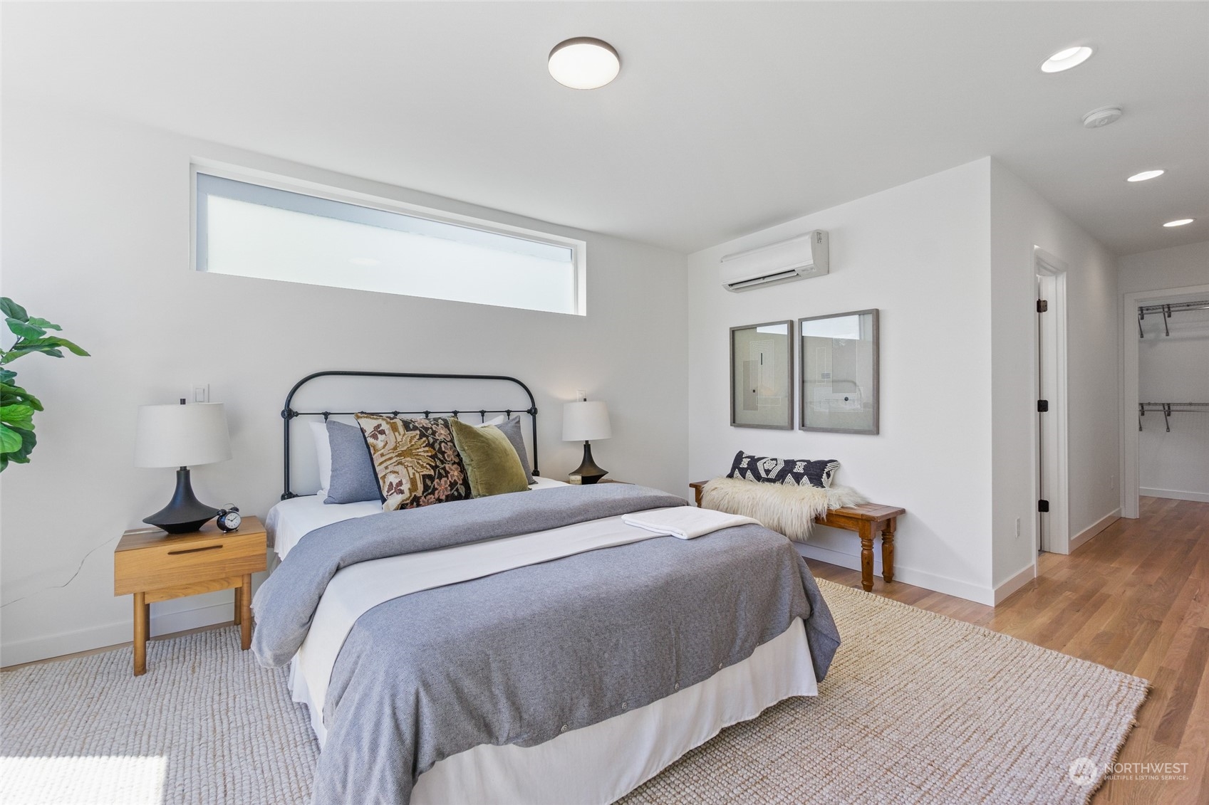 2620 Northwest 62nd Street, Unit B Seattle, WA 98107 - Photo 30 of 34 a bedroom with a bed and wooden floor