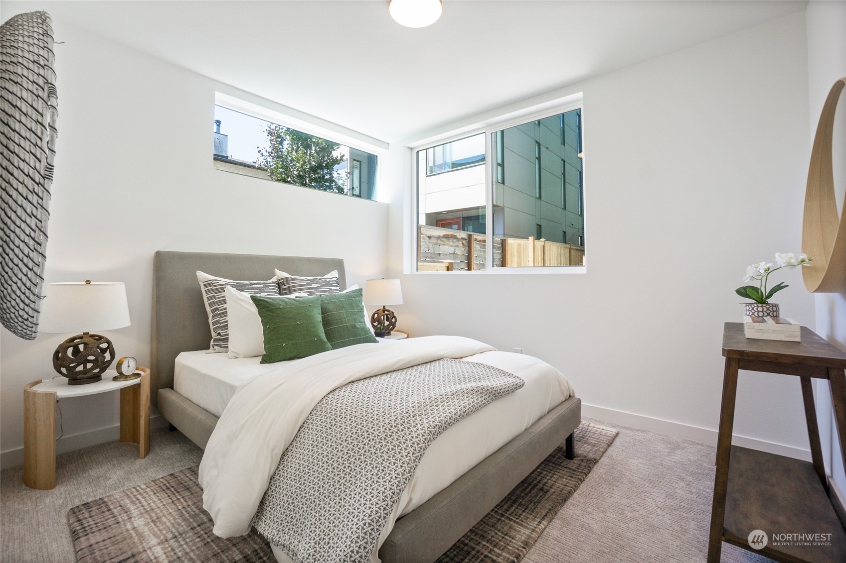 2620 Northwest 62nd Street, Unit B Seattle, WA 98107 - Photo 6 of 34 a bedroom with a bed a mirror and a window