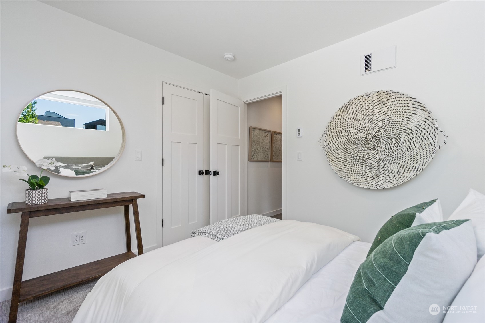 2620 Northwest 62nd Street, Unit B Seattle, WA 98107 - Photo 7 of 34 a bedroom with a bed and a mirror