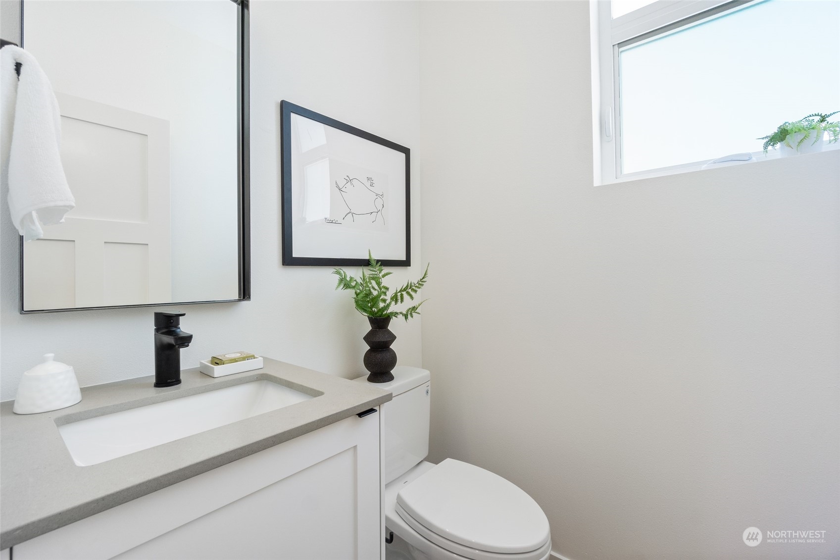 2620 Northwest 62nd Street, Unit B Seattle, WA 98107 - Photo 8 of 34 a bathroom with a toilet sink and mirror