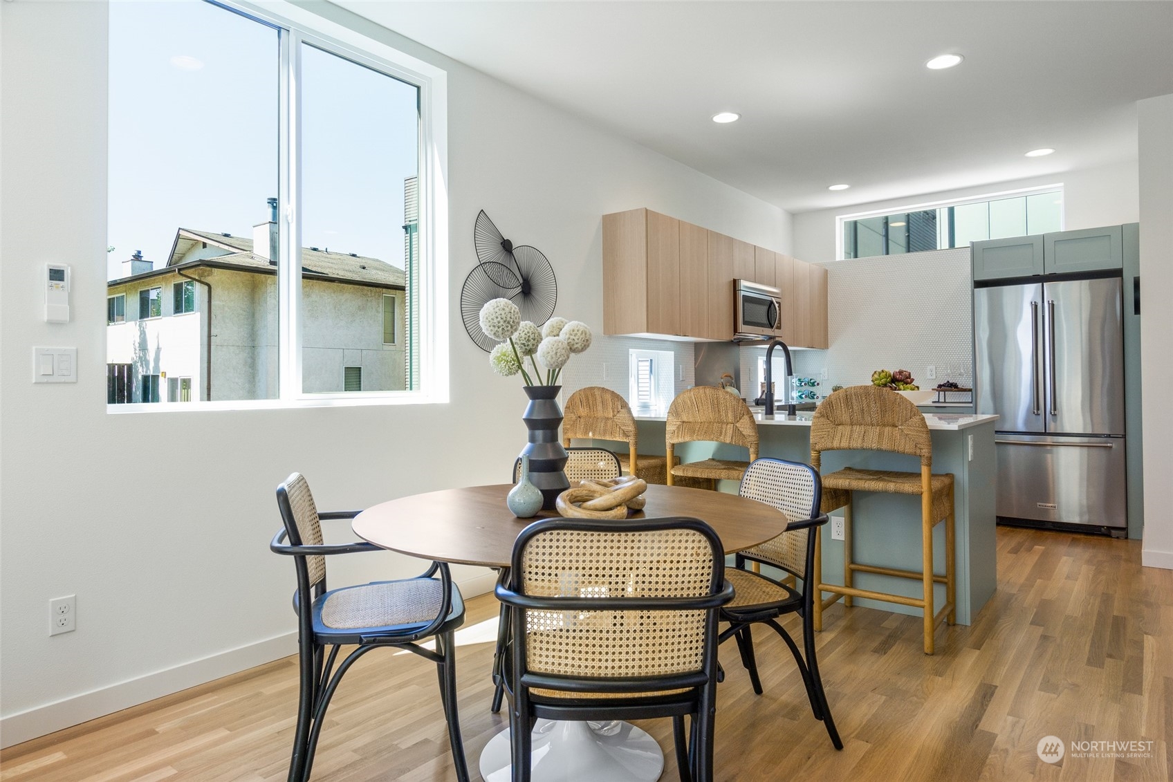 2620 Northwest 62nd Street, Unit B Seattle, WA 98107 - Photo 10 of 34 a dining room with furniture and a chandelier