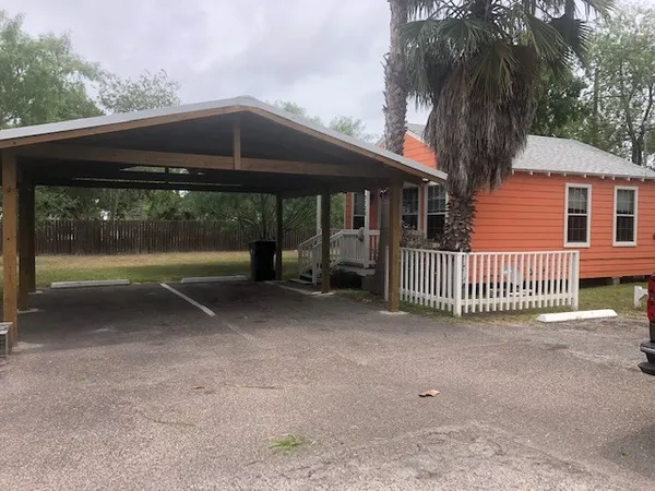 a backyard of a house with a deck and barbeque oven