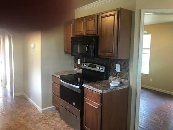 a kitchen that has a sink and a stove in it