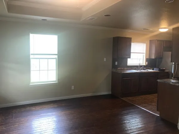 a kitchen with stainless steel appliances granite countertop a sink a stove a microwave and window
