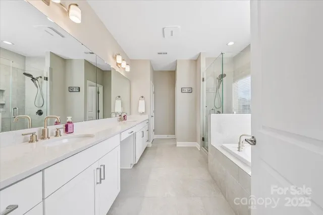 a white bath tub sitting next to a shower