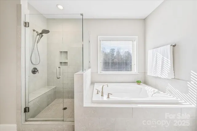 a bathroom with double vanity sinks and a mirror