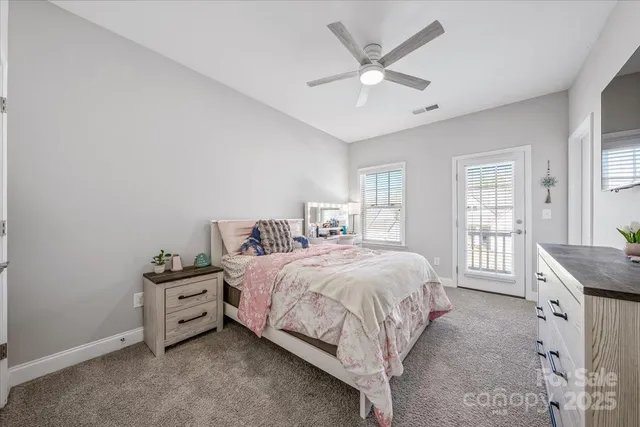 a bedroom with a bed a dresser and a window