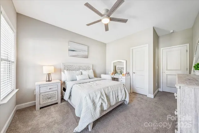 a spacious bedroom with a bed and a cabinets