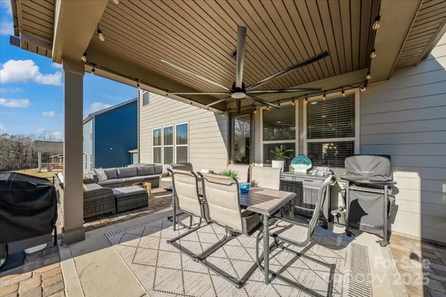 a balcony with furniture and a flat screen tv