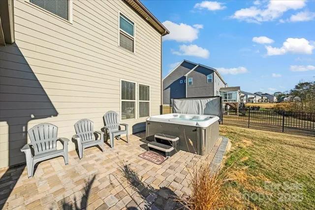 a view of a house with swimming pool and sitting area