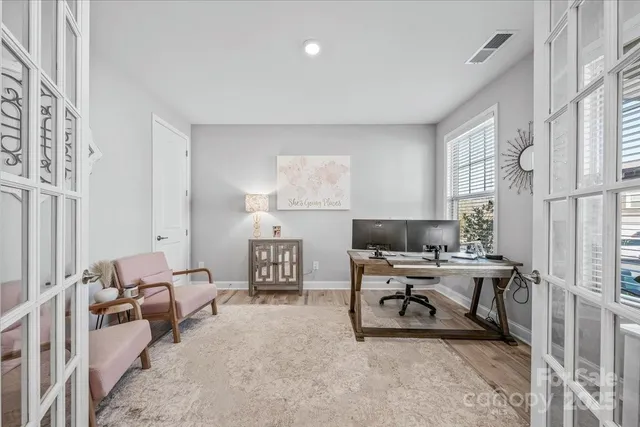 a workspace with a couch and a lamp