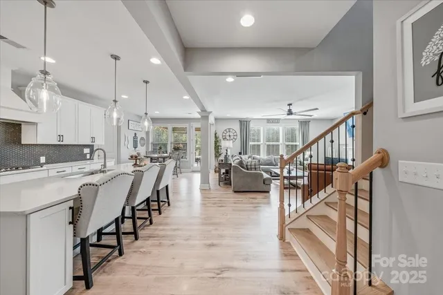a living room with lots of chairs and a table