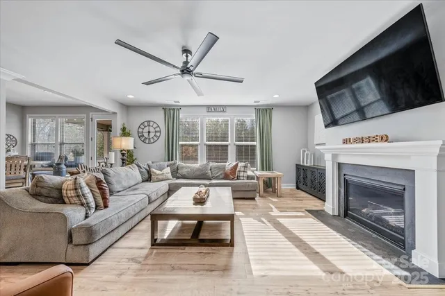 a living room with furniture a fireplace and a flat screen tv