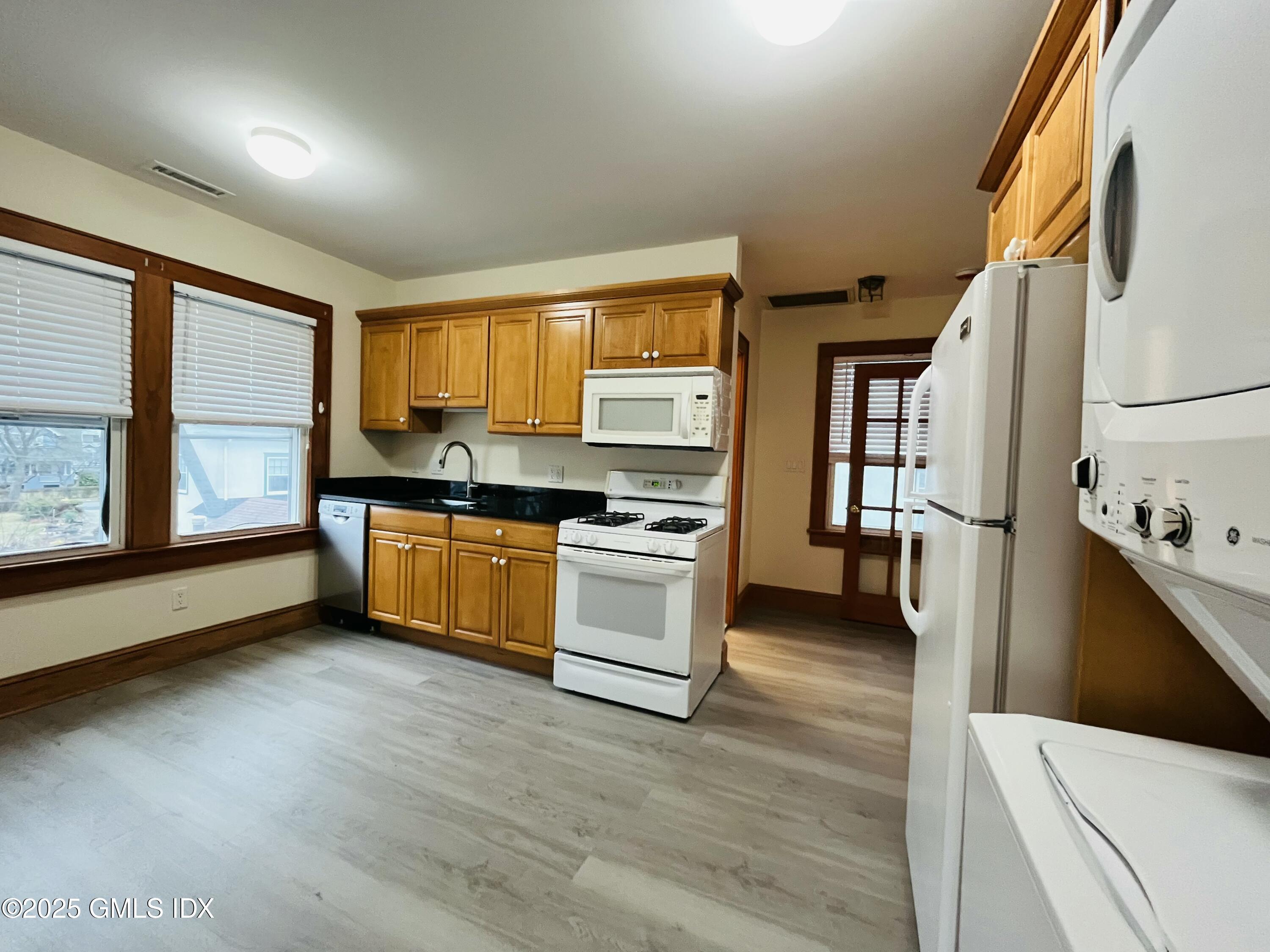 18 Grand Street, Unit 2 Greenwich, CT 06830 - Photo 3 of 10 a kitchen with stainless steel appliances a stove a sink and a refrigerator