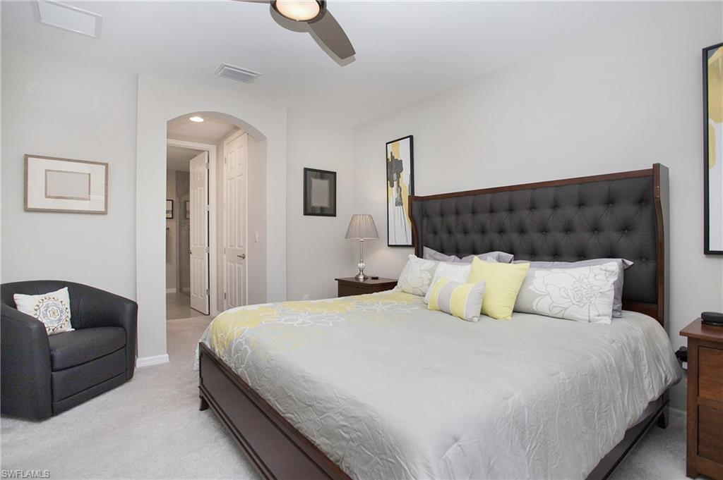 14899 Edgewater Circle Naples, FL 34114 - Photo 10 of 33 a bedroom with a bed and a couch