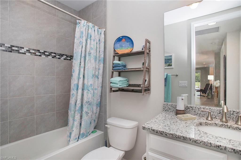 14899 Edgewater Circle Naples, FL 34114 - Photo 14 of 33 a bathroom with a granite countertop sink toilet and shower