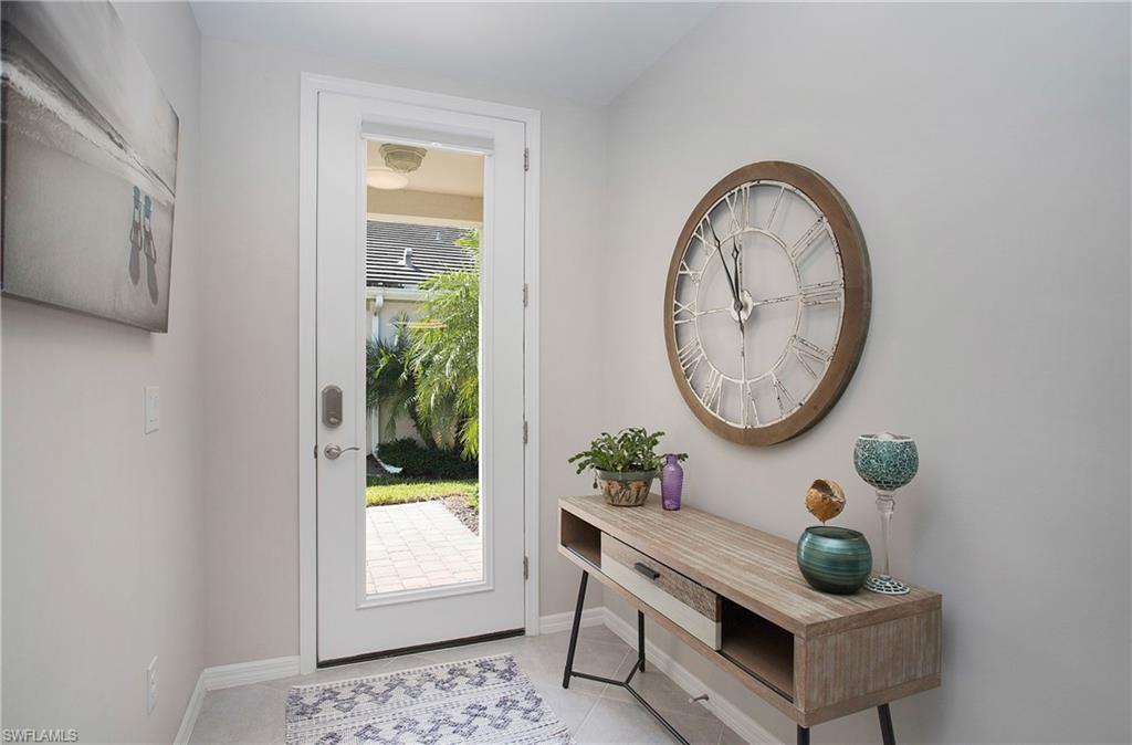 14899 Edgewater Circle Naples, FL 34114 - Photo 3 of 33 a front view of a house with garden