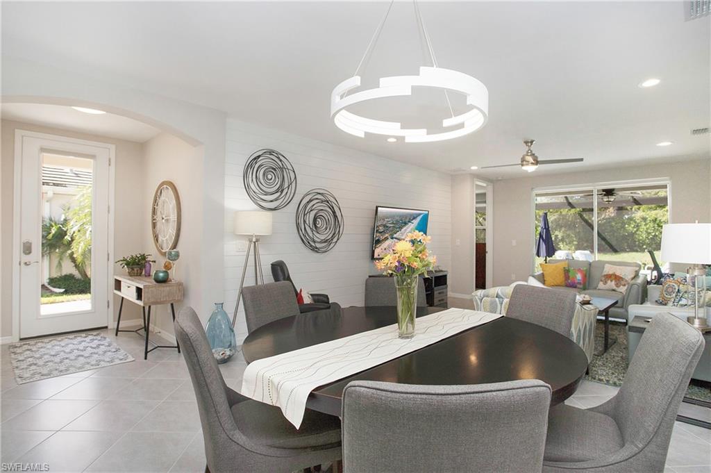 14899 Edgewater Circle Naples, FL 34114 - Photo 5 of 33 a living room with furniture and a large window