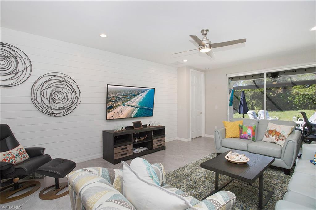 14899 Edgewater Circle Naples, FL 34114 - Photo 7 of 33 a living room with furniture and a window