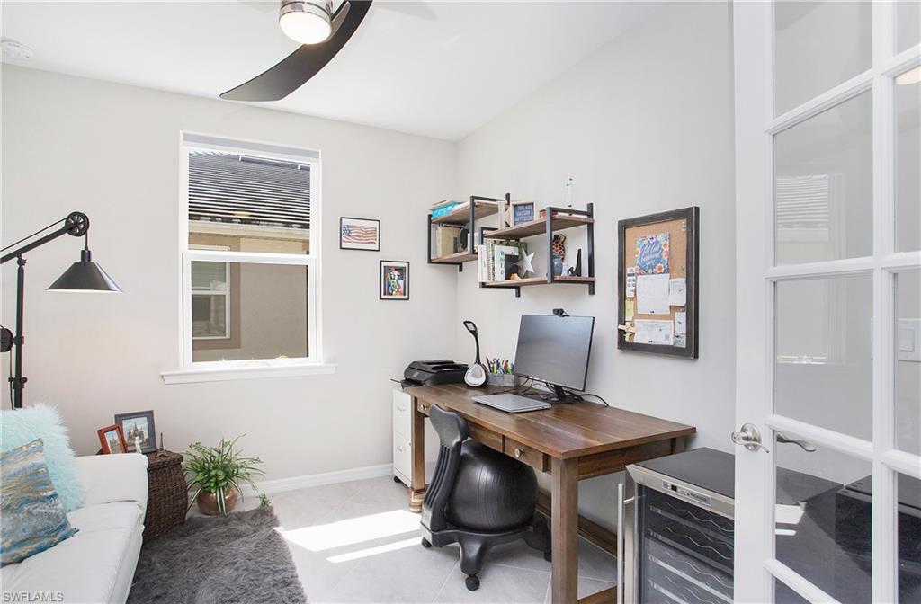 14899 Edgewater Circle Naples, FL 34114 - Photo 8 of 33 a view of a workspace with furniture and a window
