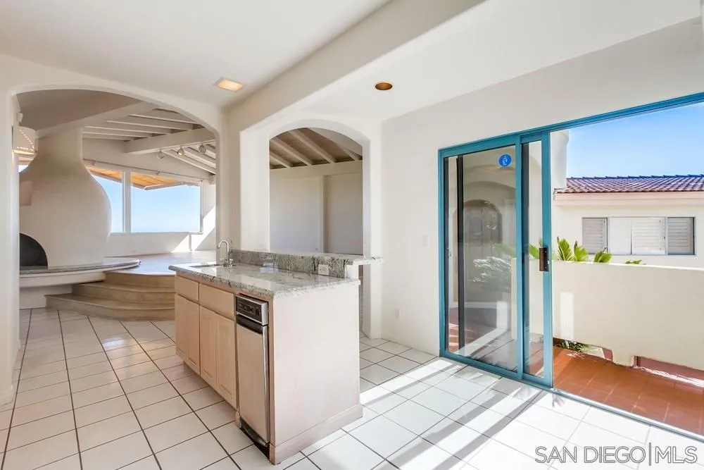 1145 La Jolla Rancho Road La Jolla, CA 92037 - Photo 13 of 45 a large white kitchen with a sink and a large window