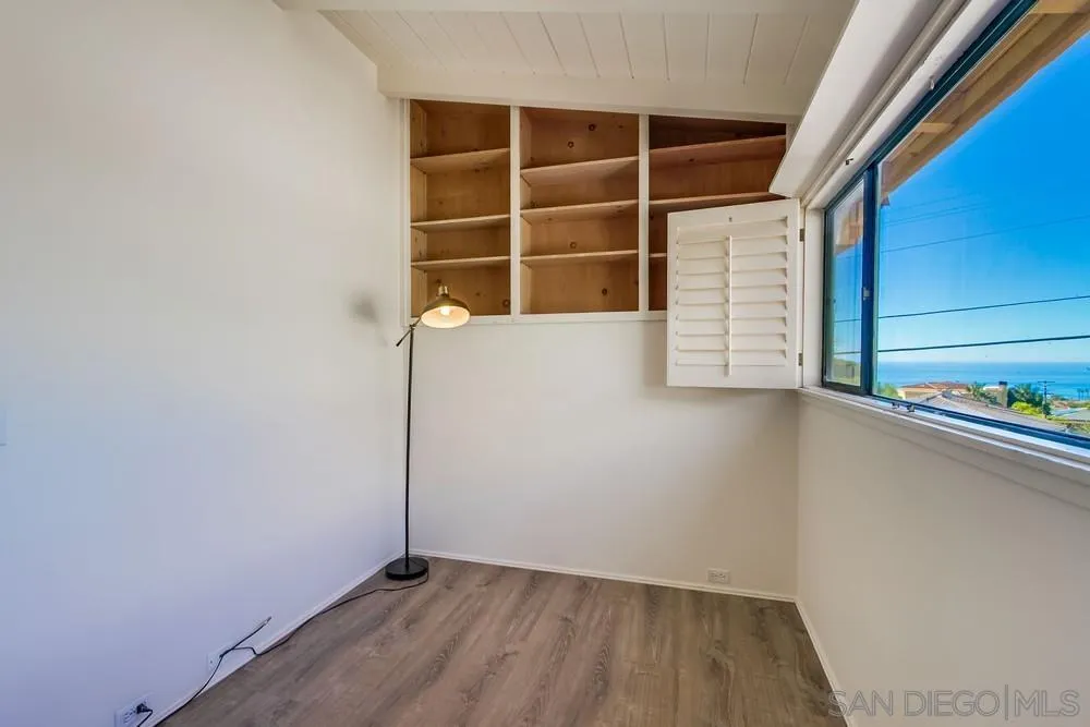 1145 La Jolla Rancho Road La Jolla, CA 92037 - Photo 27 of 45 a view of an empty room with wooden floor and a window