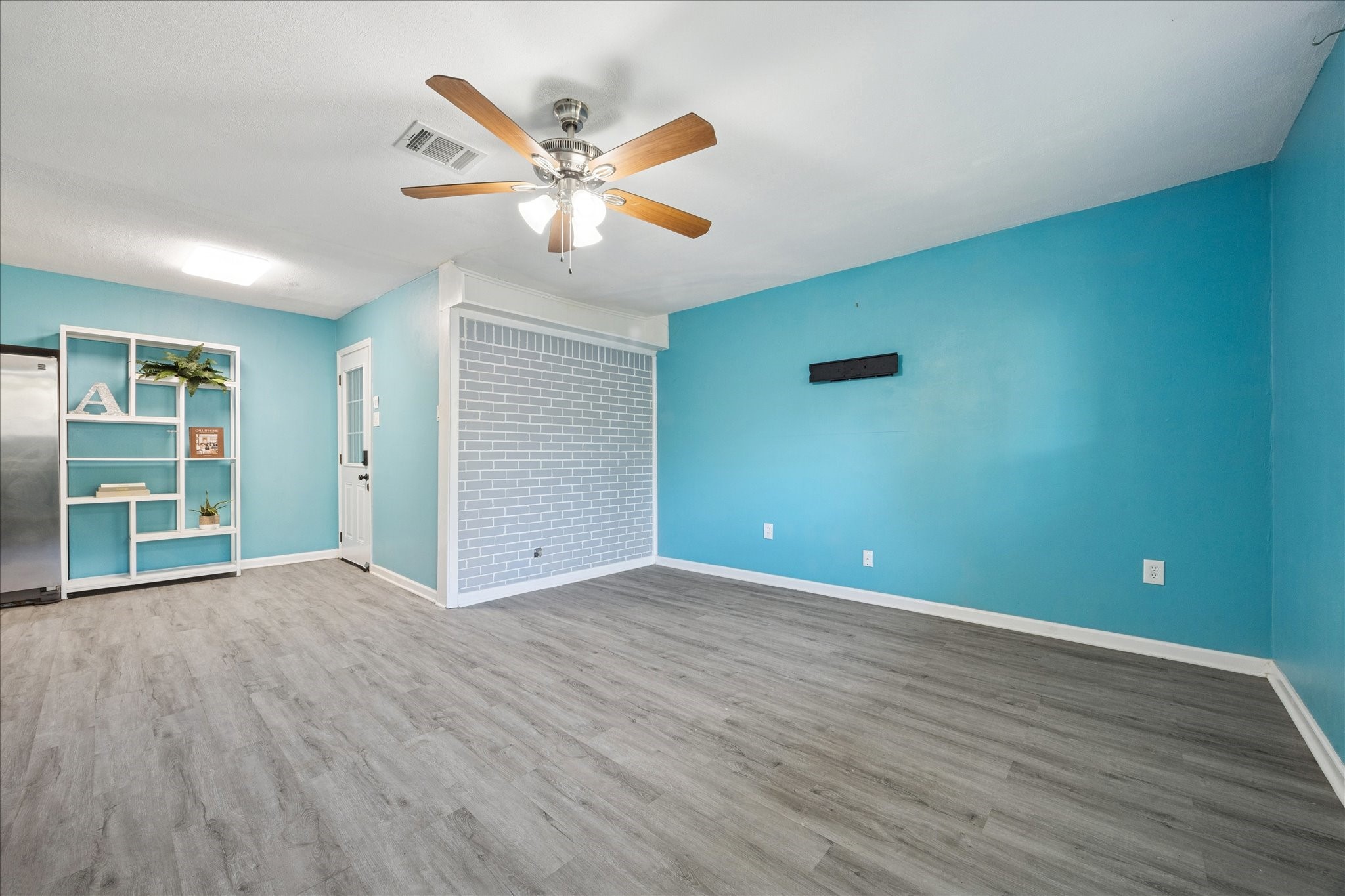 329 Robin Street Deer Park, TX 77536 - Photo 12 of 30 a view of an empty room with window and wooden floor