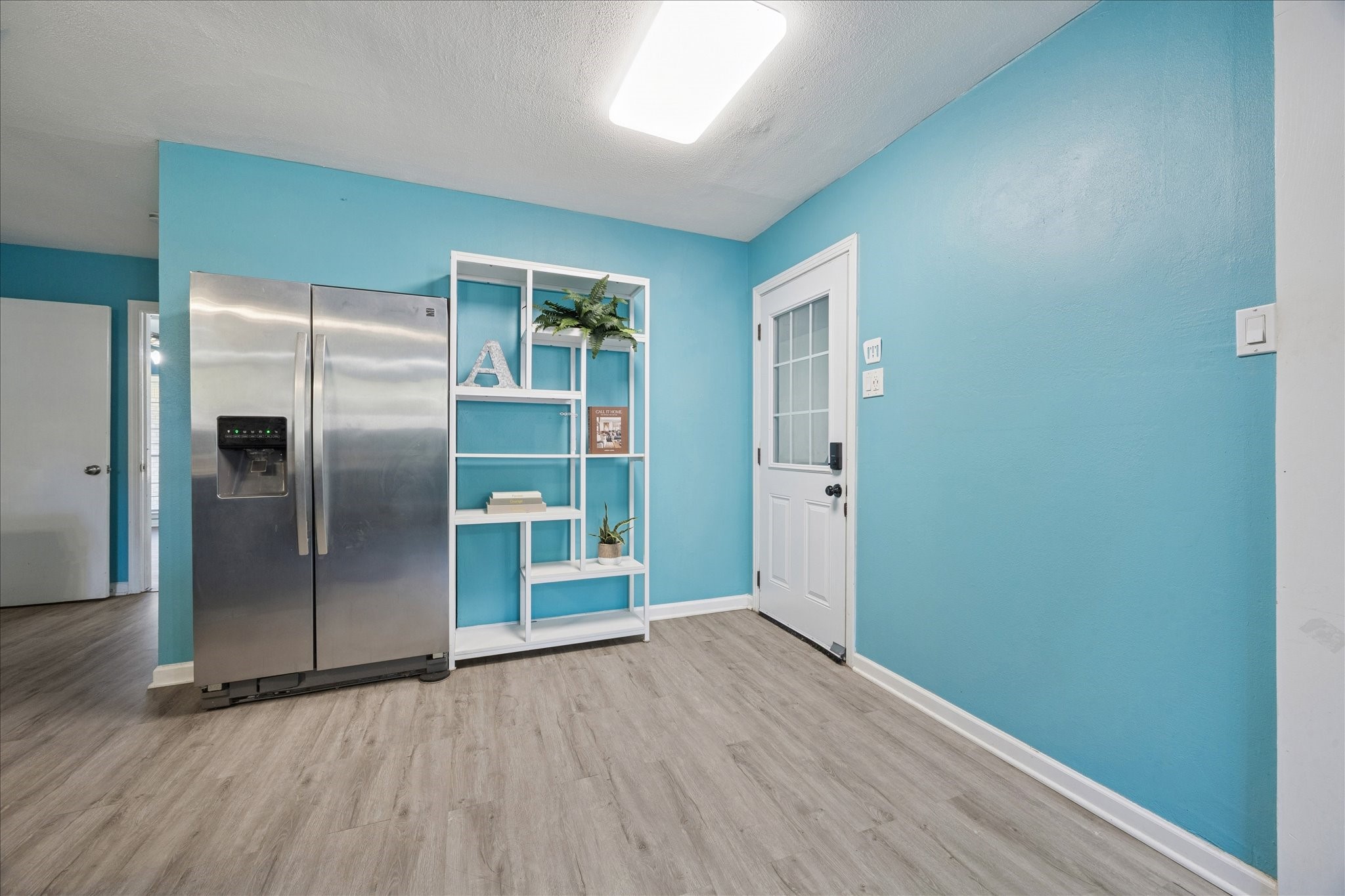 329 Robin Street Deer Park, TX 77536 - Photo 15 of 30 a view of an empty room with wooden floor and a window