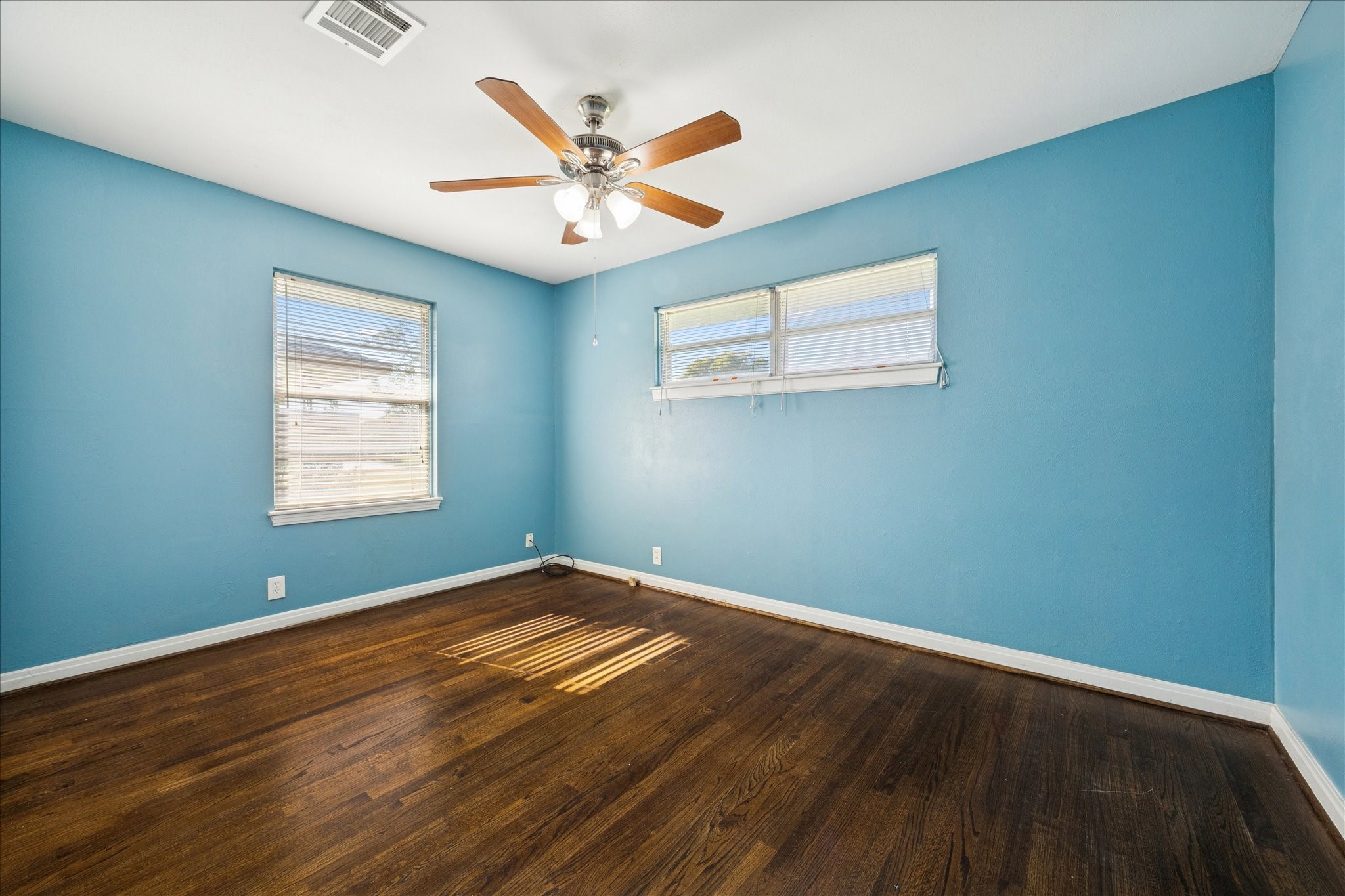 329 Robin Street Deer Park, TX 77536 - Photo 16 of 30 a view of a big room with wooden floor and windows