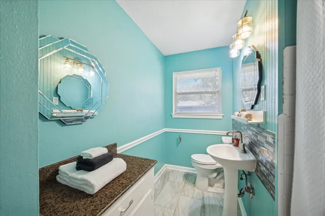 a bathroom with a sink a mirror and a window