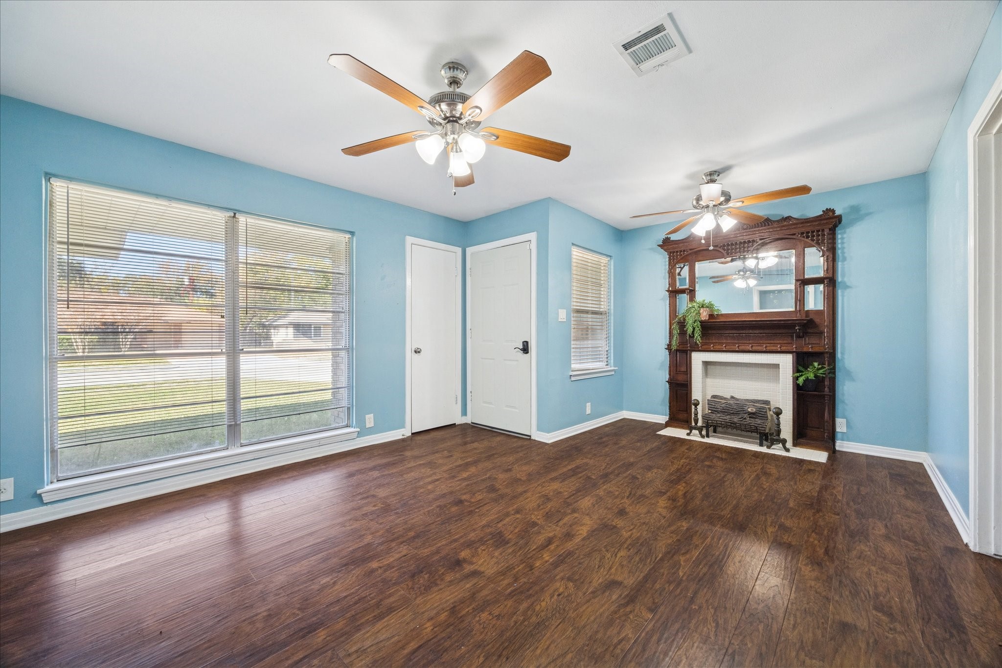 329 Robin Street Deer Park, TX 77536 - Photo 2 of 30 a view of an empty room with a window and wooden floor