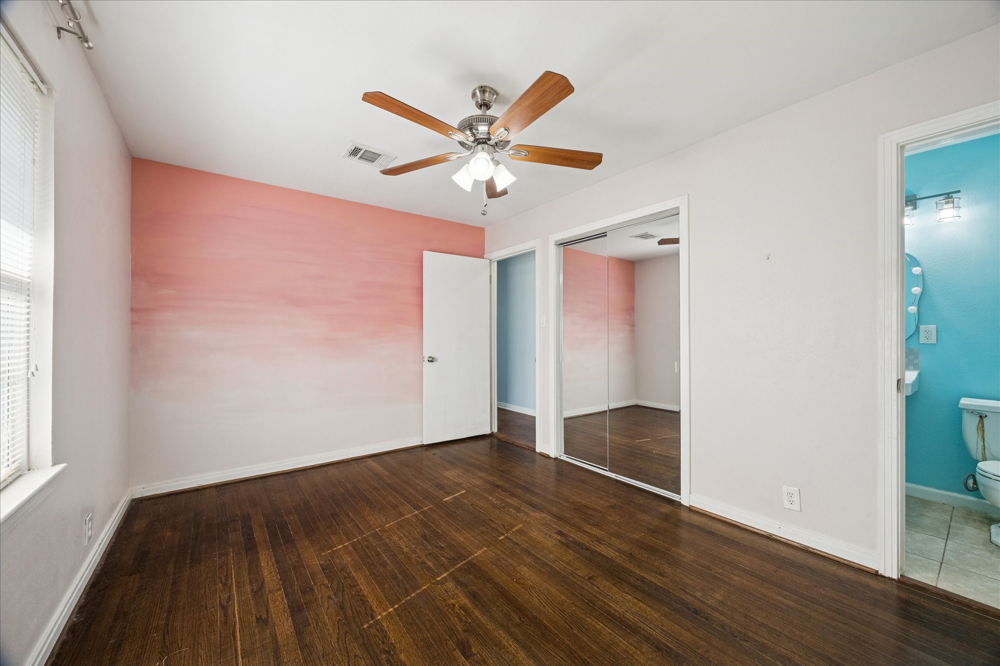 329 Robin Street Deer Park, TX 77536 - Photo 4 of 30 a view of an empty room with window and wooden floor