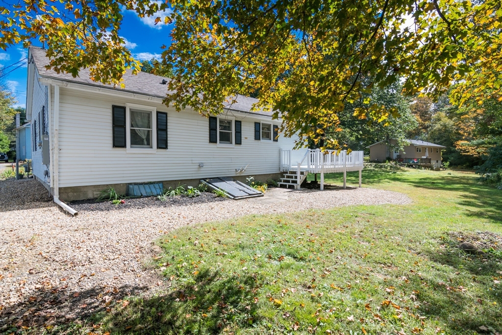82 Comins Pond Road Warren, MA 01083 - Photo 15 of 18 a front view of a house with a yard and garage