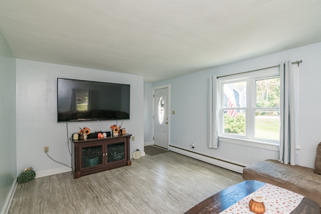 82 Comins Pond Road Warren, MA 01083 - Photo 3 of 18 a living room with furniture and a flat screen tv