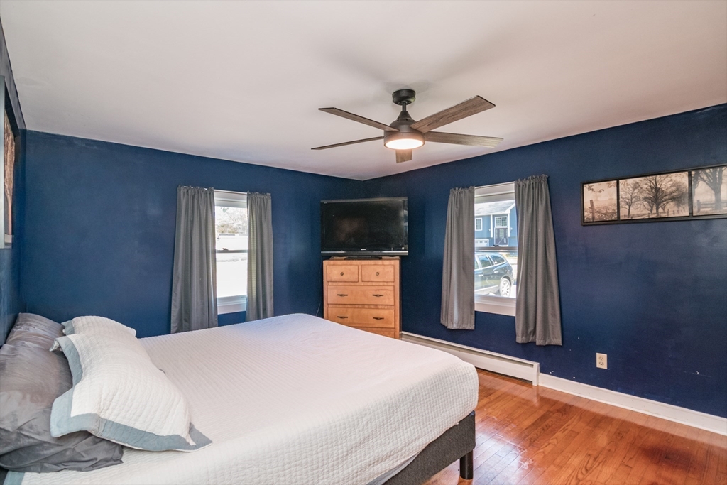 82 Comins Pond Road Warren, MA 01083 - Photo 7 of 18 a bedroom with a large bed and a window