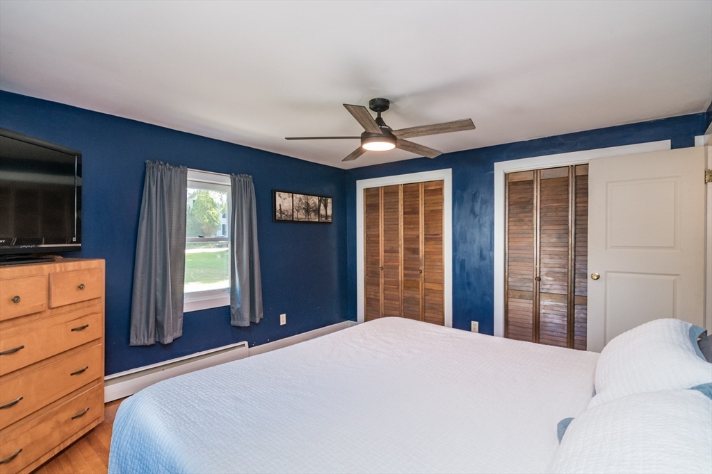82 Comins Pond Road Warren, MA 01083 - Photo 8 of 18 a bedroom with a bed and a flat screen tv