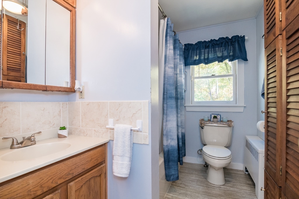 82 Comins Pond Road Warren, MA 01083 - Photo 9 of 18 a bathroom with a toilet a sink and a window