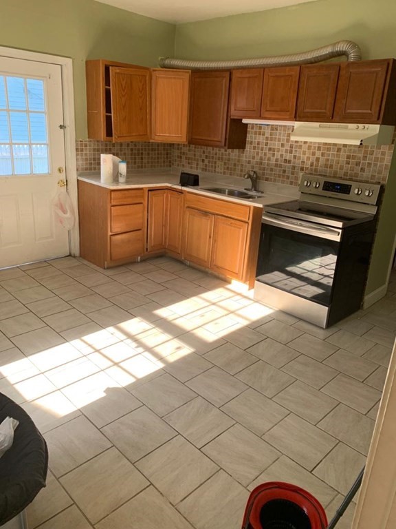 999 Rodman Street Fall River, MA 02721 - Photo 4 of 4 a kitchen with stainless steel appliances granite countertop a sink and a stove