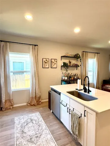 a kitchen with sink refrigerator and window