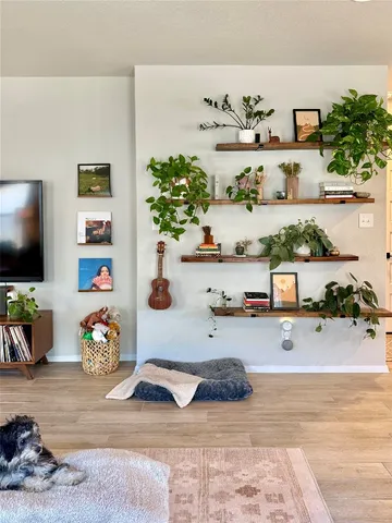 a picture of a living room with furniture and a flat screen tv