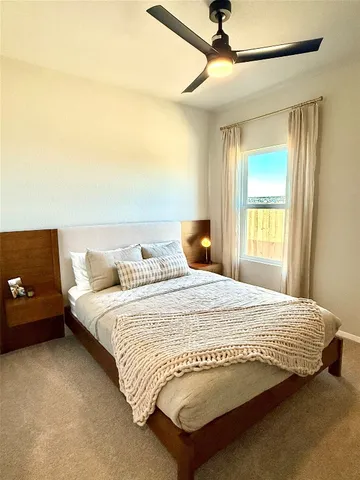 a bedroom with a bed and window