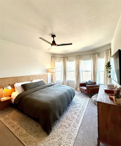 a bedroom with a bed and a couch