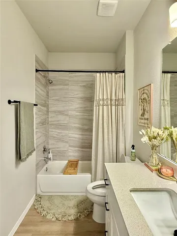 a spacious bathroom with a bathtub and sink