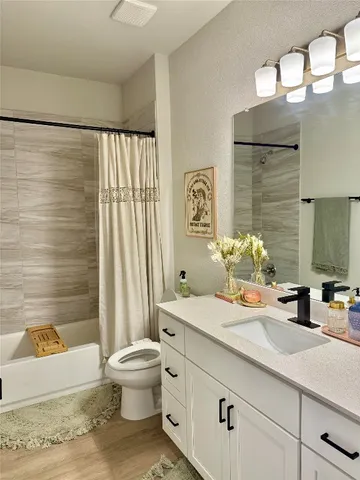 a bathroom with a double vanity sink toilet and shower