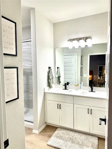 a bathroom with a sink a mirror and a shower