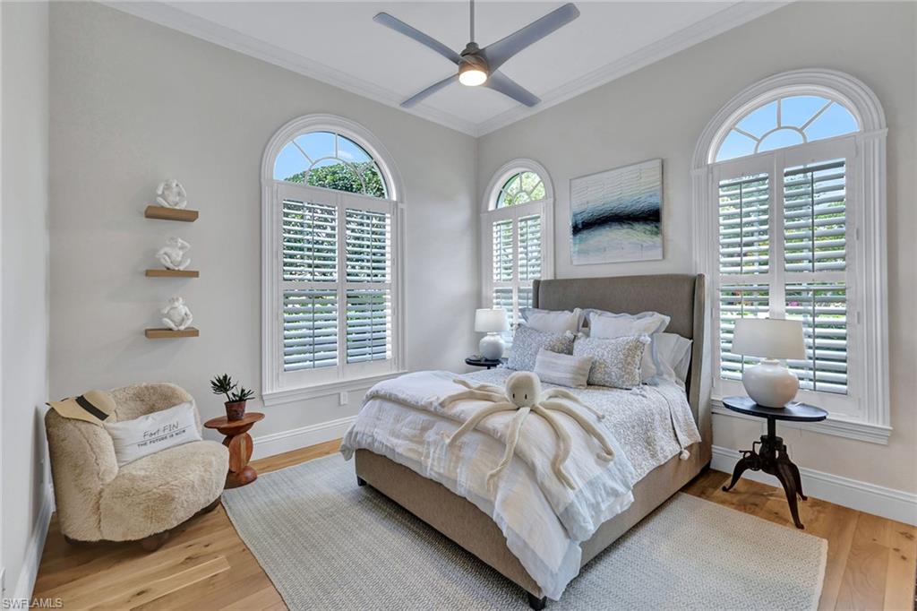 709 Teal Court Naples, FL 34108 - Photo 13 of 39 a bedroom with a bed and a couch