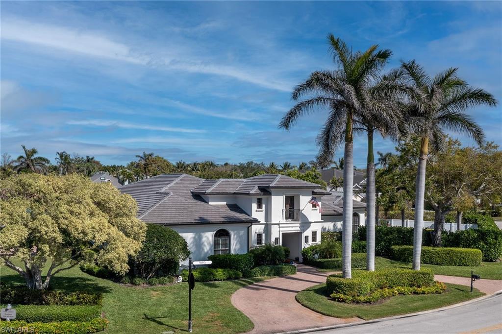 709 Teal Court Naples, FL 34108 - Photo 32 of 39 a front view of a house with a garden and yard