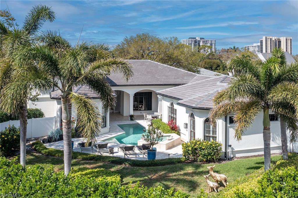 709 Teal Court Naples, FL 34108 - Photo 34 of 39 a front view of a house with garden