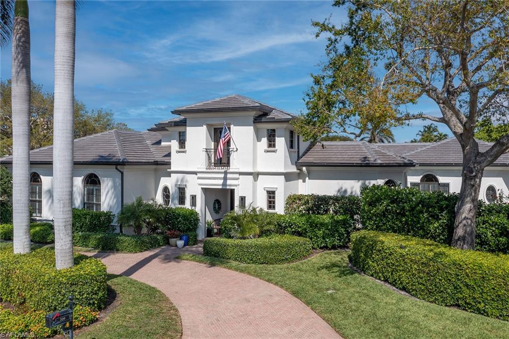 709 Teal Court Naples, FL 34108 - Photo 38 of 39 a front view of a house with garden