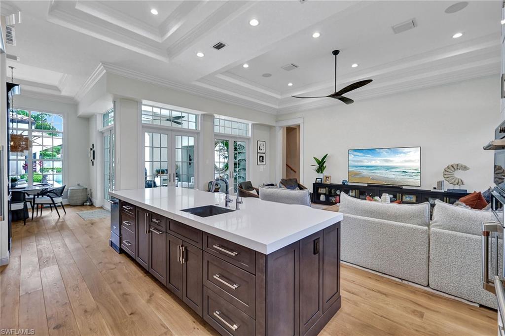 709 Teal Court Naples, FL 34108 - Photo 4 of 39 a large kitchen with stainless steel appliances a large island in the center
